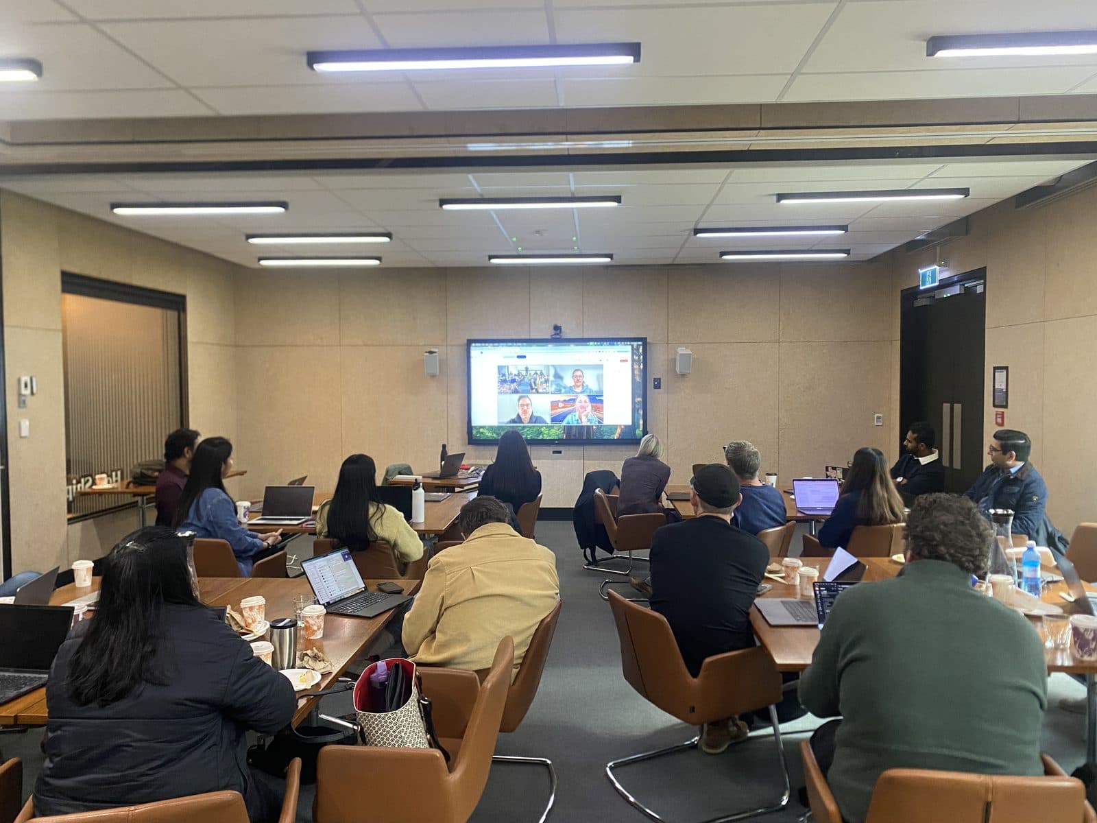 A live accelerator session with EROAD team members in the room and colleagues joining remotely on screen.