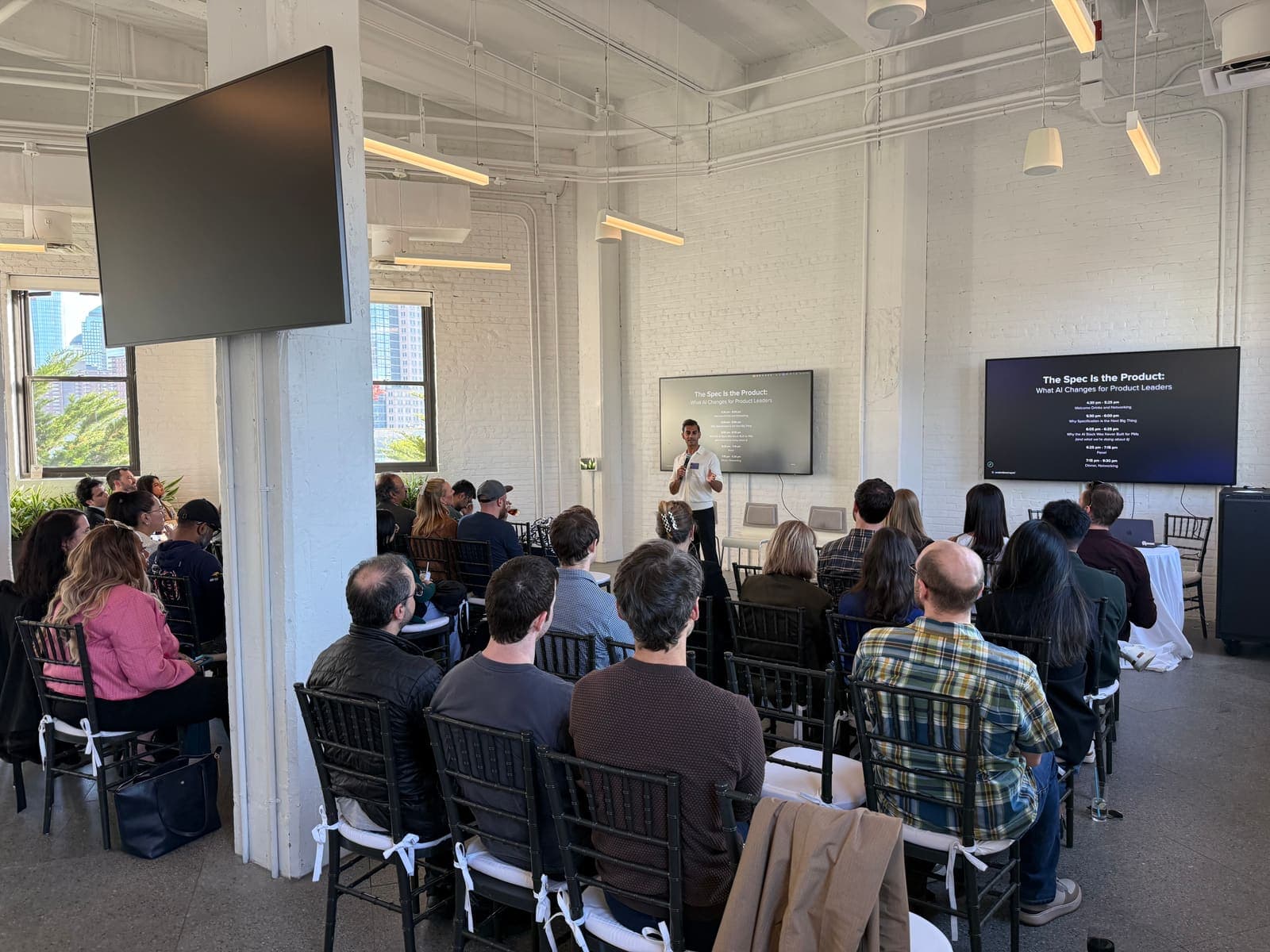Product leaders listening to a talk at a Productboard Spark workshop.